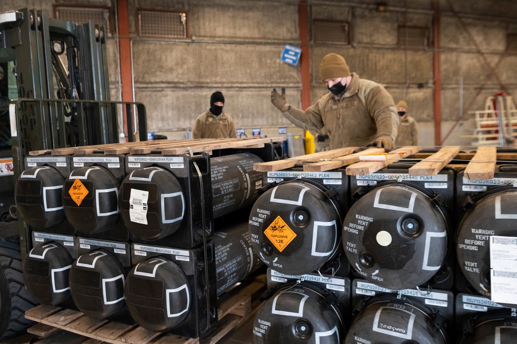 Airmen and civilians from the 436th Aerial Port Squadron palletize ammunition, weapons and other equipment bound for Ukraine.