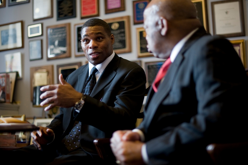 Walker chats with the late Georgia Sen. John Lewis in his Trump-appointed role as the co-chair of the President’s Fitness Council.