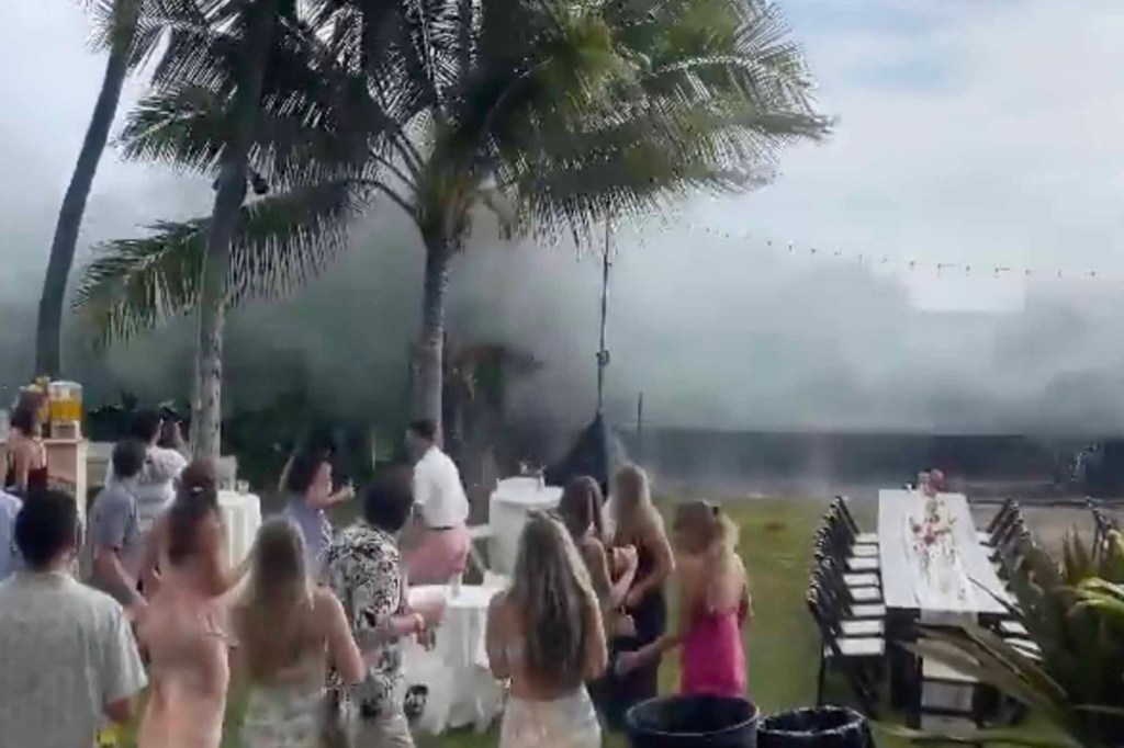 Huge wave crashes down on wedding reception