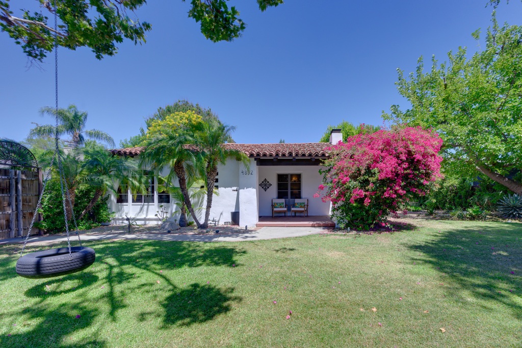 The Spanish-style home dates to the 1920s and has a modest exterior colored by a bright bougainvillea.