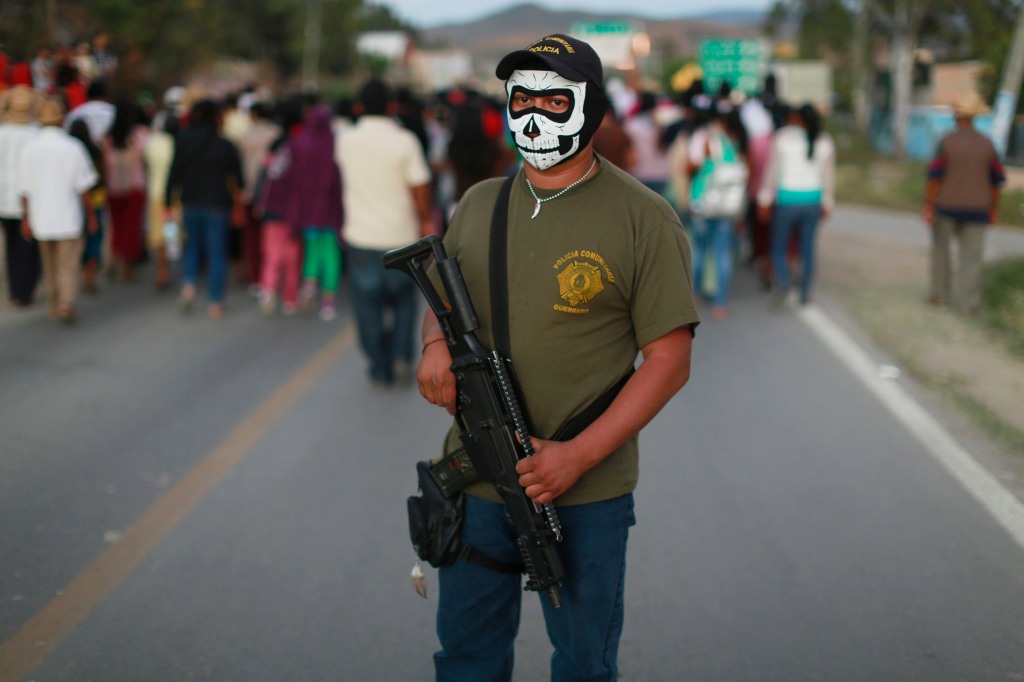 A police officer of Guerrero stands guard during a demonstration demanding justice for the 43 missing trainee teachers of Ayotzinapa in 2014.