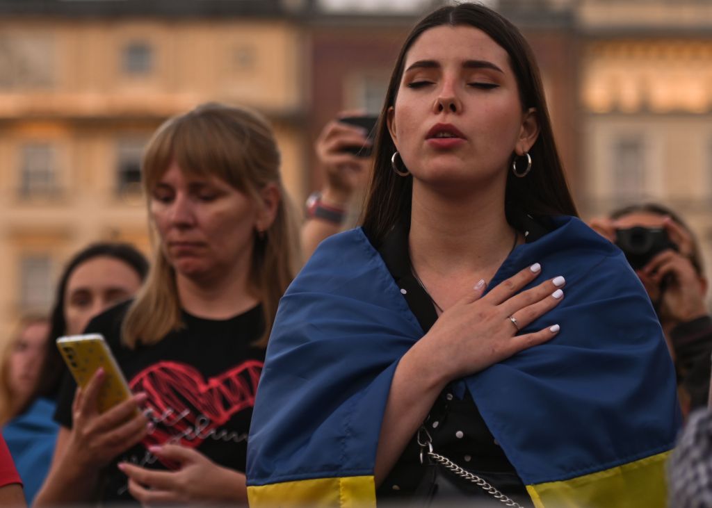 A Ukrainian woman is seen during the Ukrainian National Anthem on the eve of Ukraine's Independence Day on Aug. 23, 2022.