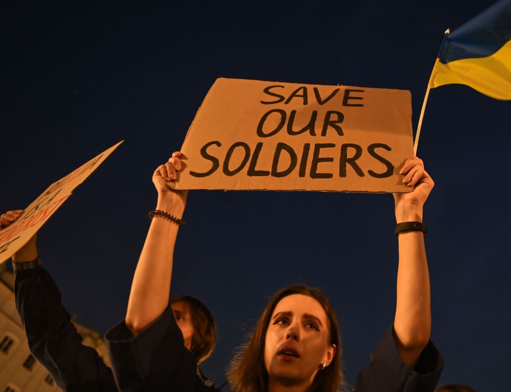 A Ukrainian woman holds a placard during a candlelight vigil on the eve of Ukraine's Independence Day in Krakow Market Square on Aug. 23, 2022.