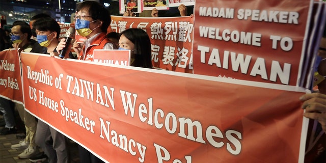 Supporters hold a banner outside the hotel where House Speaker Nancy Pelosi is supposed to be staying in Taipei, Taiwan, Tuesday, Aug 2, 2022.