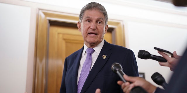 Sen. Joe Manchin, D-W.Va., is met by reporters outside the hearing room where he chairs the Senate Committee on Energy and Natural Resources, at the Capitol in Washington, July 21, 2022.