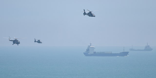 Chinese military helicopters fly past Pingtan island, one of mainland China's closest point from Taiwan, in Fujian province on Aug. 4, 2022.