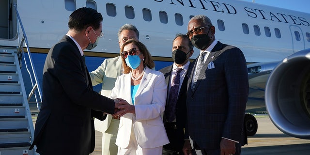 Taiwan's Foreign Minister Joseph Wu, left, speaks with House Speaker Nancy Pelosi as she prepares to leave in Taipei, Taiwan, Aug. 3, 2022. (Taiwan Ministry of Foreign Affairs via AP)