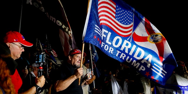 Supporters of former President Trump rally near Trump's Mar-A-Lago home Aug. 8, 2022, in Palm Beach, Fla. The FBI raided the home to retrieve classified White House documents. 