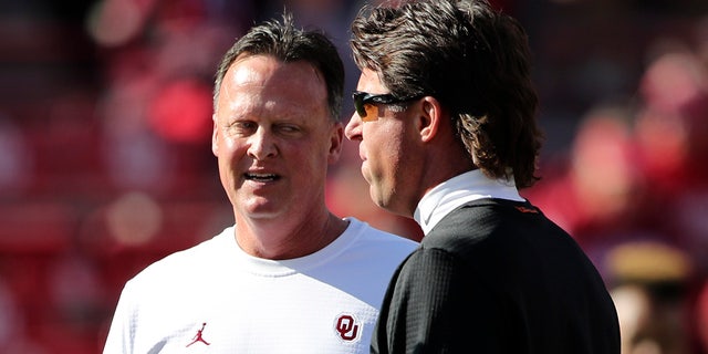 Gundy, left, speaks with his brother, Oklahoma State Cowboys head coach Mike Gundy, before the game at Gaylord Family - Oklahoma Memorial Stadium in Norman, Oklahoma, on Nov. 10, 2018.