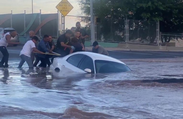 Woman dramatically saved from sinkhole before car swallowed