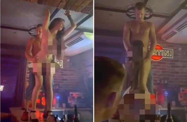 Bouncer has sex with naked woman in nightclub as patrons cheer