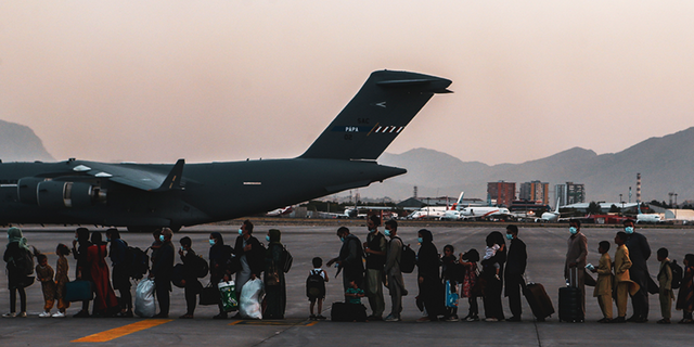 Evacuees wait to board a Boeing C-17 Globemaster III during an evacuation at Hamid Karzai International Airport, Kabul, Afghanistan, Aug. 23, 2021.