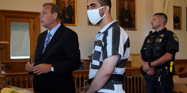 Hadi Matar, 24, listens as his public defense attorney Nathaniel Barone addresses the judge during an arraignment in the Chautauqua County Courthouse in Mayville, New York, Saturday, Aug. 13, 2022.