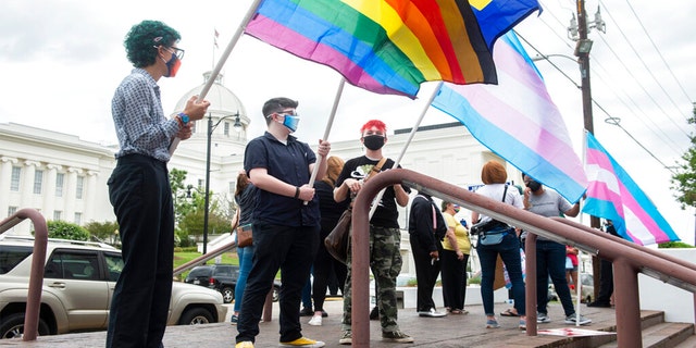 File photo of people holding trans and gay pride flags. Grant Sikes, a biological male, wrote in a statement to Instagram that every campus sorority denied the transgender individual.