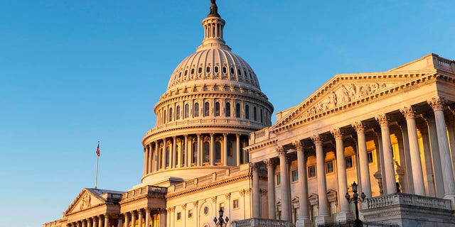 The U.S. Capitol dome is lit by the morning sun.