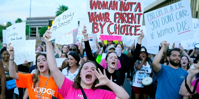 Protesters shout as they join thousands marching around the Arizona Capitol after the Supreme Court decision to overturn the landmark Roe v. Wade abortion decision.