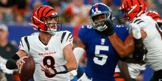 Cincinnati Bengals quarterback Brandon Allen (8) throws a pass as New York Giants' Kayvon Thibodeaux (5) rushes him during the first half of a preseason NFL football game Sunday, Aug. 21, 2022, in East Rutherford, N.J.