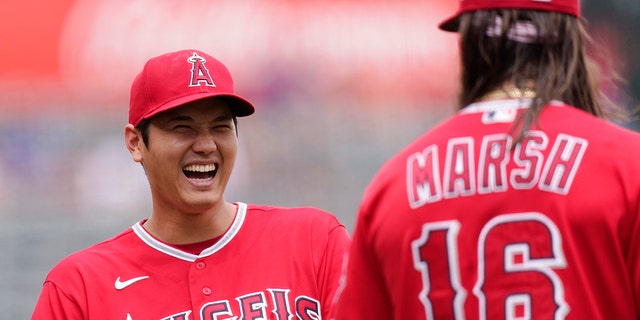 Los Angeles Angels' Shohei Ohtani talks to Brandon Marsh before a game against the Texas Rangers on July 31, 2022, in Anaheim, California.