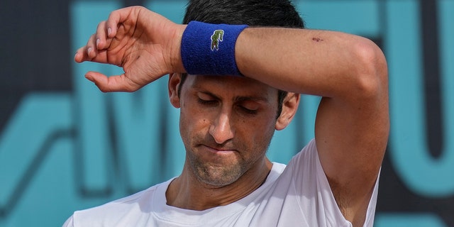 Novak Djokovic wipes the sweat off during a training session at the Mutua Madrid Open in Spain, April 30, 2022.