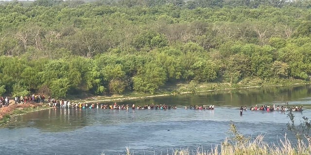 July 13, 2022: Migrants stream across the Texas border.