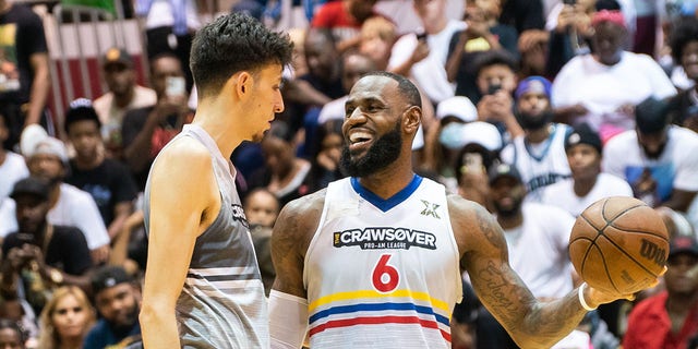 Chet Holmgren greets LeBron James during the CrawsOver Pro-Am game at Seattle Pacific University on Aug. 20, 2022, in Seattle.