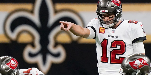 Tampa Bay Buccaneers quarterback Tom Brady (12) signals at the line of scrimmage against the New Orleans Saints during the first half of an NFL divisional round playoff football game, Sunday, Jan. 17, 2021, in New Orleans.