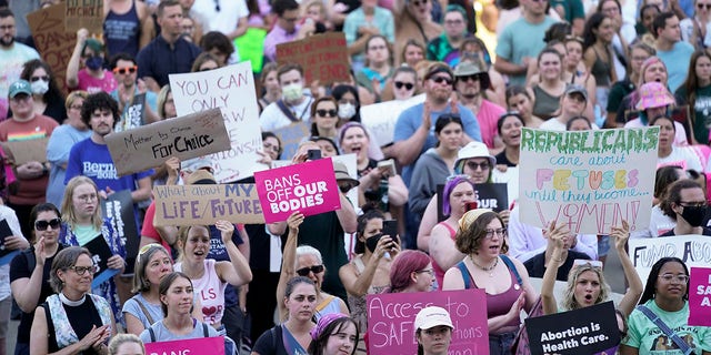 Abortion rights protesters cheer at a rally following the United States Supreme Court's decision to overturn Roe v. Wade, federally protected right to abortion, outside the state capitol in Lansing, Mich. 