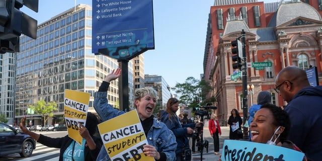 Activists demonstrate outside an entrance to the White House calling for the cancellation of student debt in Washington April 27, 2022. 