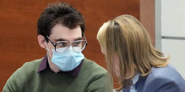 Marjory Stoneman Douglas High School shooter Nikolas Cruz speaks with Assistant Public Defender Melisa McNeill at the Broward County Courthouse in Fort Lauderdale, Florida, April 4, 2022.