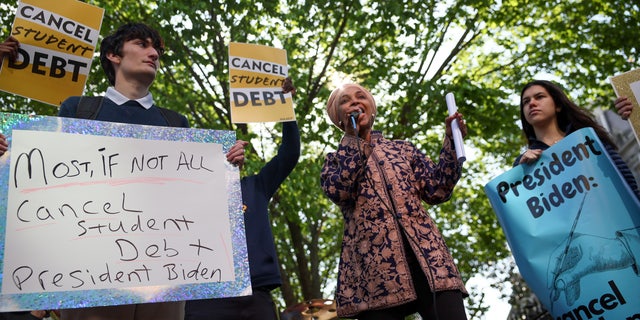 Rep. Ilhan Omar, D-Minn., joins activists in a demonstration outside an entrance to the White House, calling for the cancellation of student debt in Washington April 27, 2022. 