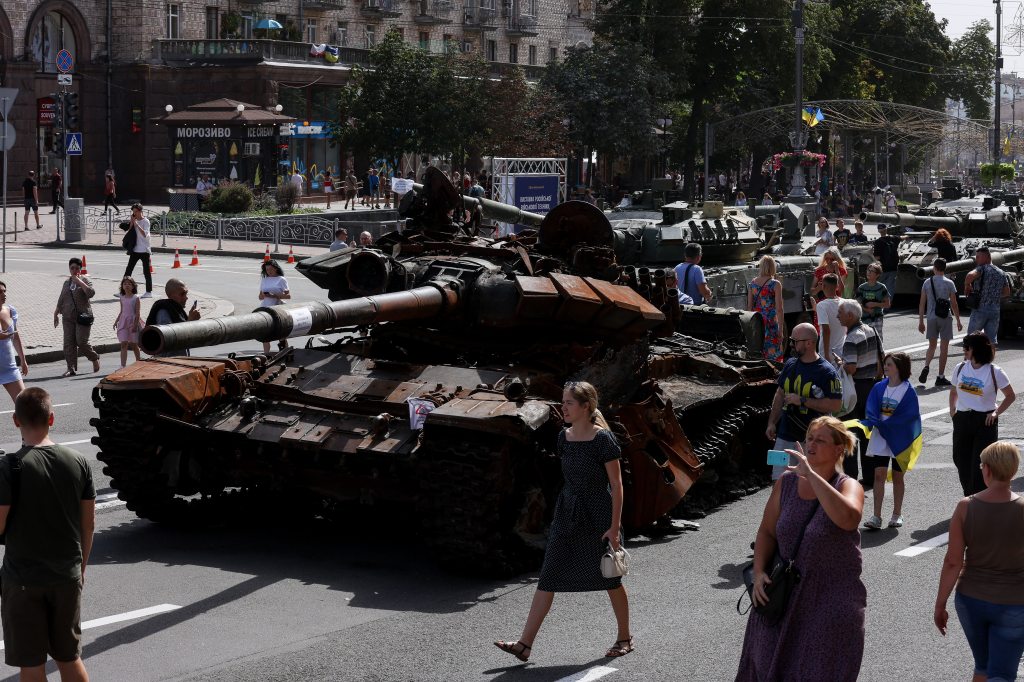 Ukrainians walk to see Russian military machinery damaged on Khreshchatyk street ahead of Independence Day in Kyiv on August 22, 2022.