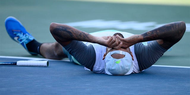 Nick Kyrgios, of Australia, lies on the court after he defeated Yoshihito Nishioka, of Japan, during a final at the Citi Open tennis tournament Sunday, Aug. 7, 2022, in Washington. Kyrgios won 6-4, 6-3.