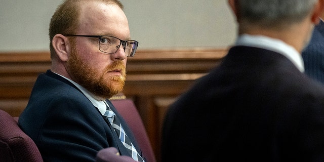 Travis McMichael listens to one of his attorneys during a motion hearing in the Glynn County Courthouse, Thursday, Nov. 4, 2021, in Brunswick, Ga. 