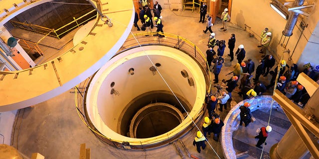 FILE - In this file photo dated Monday, Dec. 23, 2019, released by the Atomic Energy Organization of Iran, showing technicians at the Arak heavy water reactor's secondary circuit, as officials and media visit the site, near Arak, 150 miles (250 kilometers) southwest of the capital Tehran, Iran. 