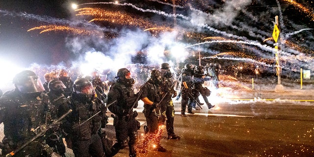 Police use chemical irritants and crowd control munitions to disperse protesters during a demonstration in Portland.