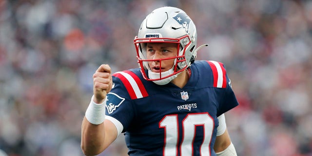 New England Patriots quarterback Mac Jones celebrates a touchdown by Rhamondre Stevenson during the second half against the Cleveland Browns on Nov. 14, 2021, in Foxborough, Mass.