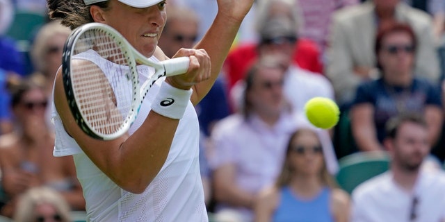 Poland's Iga Swiatek returns to Croatia's Jana Fett in a women's singles match at the Wimbledon tennis championships in London June 28, 2022. 