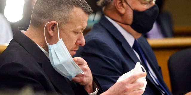 Paul Flores puts on a new N95 mask Aug. 3, 2021, at a preliminary hearing in San Luis Obispo, Calif.