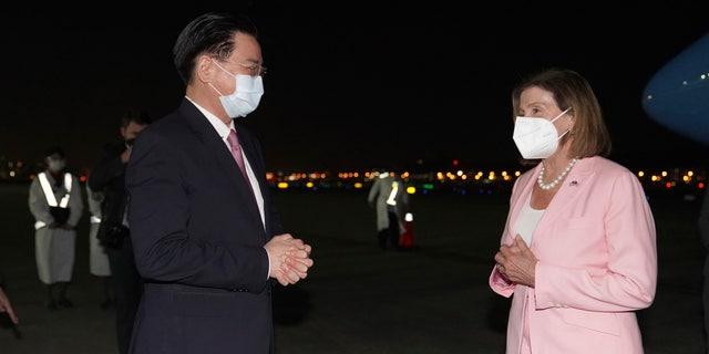 U.S. House Speaker Nancy Pelosi, right, is greeted by Taiwan's Foreign Minister Joseph Wu as she arrives in Taipei, Taiwan, Tuday, Aug. 2, 2022.