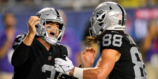 Las Vegas Raiders quarterback Jarrett Stidham (3) celebrates with tight end Jacob Hollister (88) after Stidham scrambled for a touchdown during the first half of the team's NFL football exhibition Hall of Fame Game against the Jacksonville Jaguars, Thursday, Aug. 4, 2022, in Canton, Ohio. 