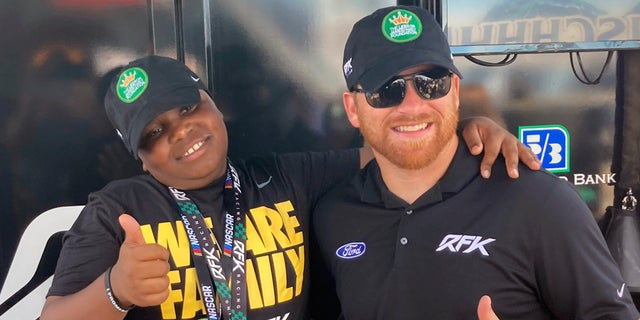 James Bromsey III, left, a sixth-grader at LeBron James' I Promise School in Akron, Ohio, poses with NASCAR driver Chris Buescher in Brooklyn, Michigan. Bromsey was given an all-access tour of Michigan International Speedway on Sunday. Chris Buescher’s No. 17 Ford had a paint job that highlighted the LeBron James Family Foundation. 