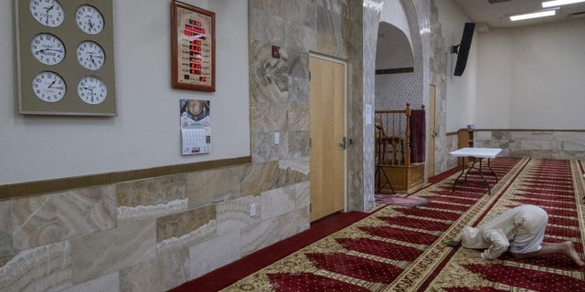 A Muslim man praying on Sunday at the Islamic Center of New Mexico after the fourth Muslim man was murdered in Albuquerque.