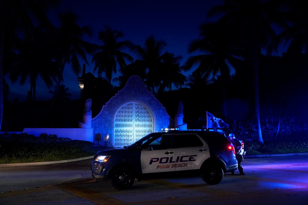 Police stand outside an entrance to former President Donald Trump's Mar-a-Lago estate, Monday, Aug. 8, 2022, in Palm Beach, Fla.
