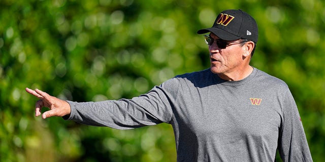 Commanders coach Ron Rivera waves to fans as he arrives for practice Tuesday, Aug. 9, 2022, in Ashburn, Virginia.