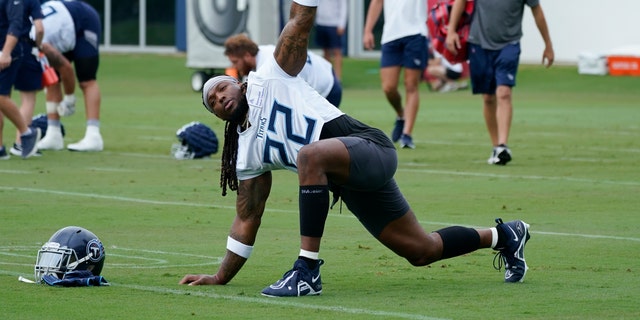 Tennessee Titans running back Derrick Henry stretches during NFL football training camp July 27, 2022, in Nashville, Tennessee. The NFL essentially is back to normal going into its third season dealing with COVID-19.