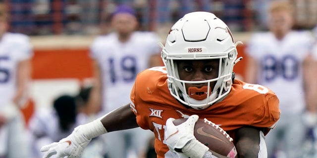 Texas' Xavier Worthy, above, runs with the ball against Kansas State during the first half of an NCAA college football game in Austin, Texas. Texas starts the season unranked after a 5-7 finish in 2021. 