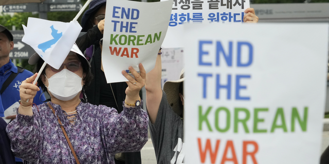 FILE - A participant waves a reunification flag during a rally for peace unification of the Korean peninsula at the Imjingak Pavilion in Paju, South Korea, near the border with North Korea, Saturday, July 23, 2022. (AP Photo/Ahn Young-joon, File)