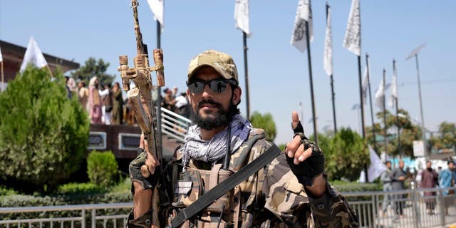 A Taliban fighter holds his weapon during a celebration marking the first anniversary of the withdrawal of US-led troops from Afghanistan, in front of the U.S. Embassy in Kabul, Afghanistan, Wednesday, Aug. 31, 2022. 