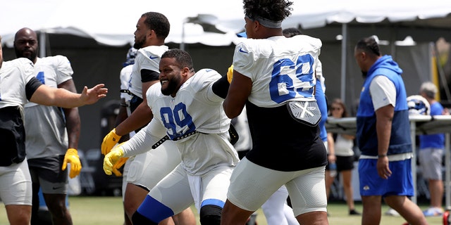 Los Angeles Rams defensive lineman Aaron Donald (99) does drills with defensive lineman Elijah Garcia (69) during training camp at University of California Irvine, July 30, 2022, in Irvine, California.