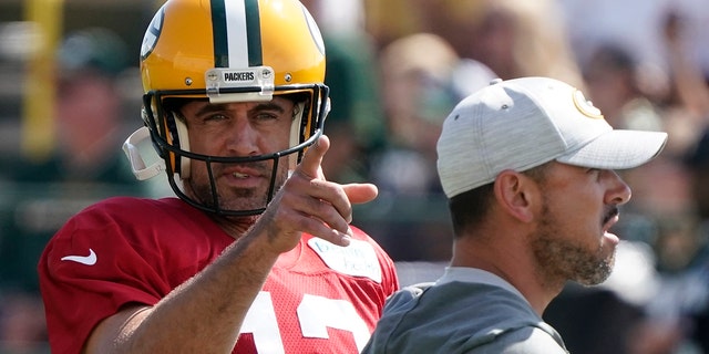 Green Bay Packers' Aaron Rodgers runs a drill before a joint practice session with the New Orleans Saints on Aug. 16, 2022, in Green Bay, Wisconsin.